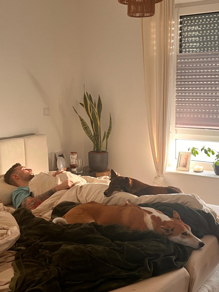 Miguel asleep in bed with Tara and Zara